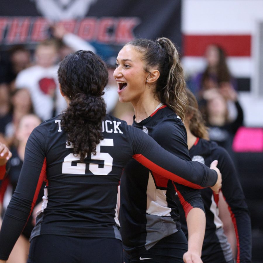 The Rock School volleyball athletes celebrate after a point scored.